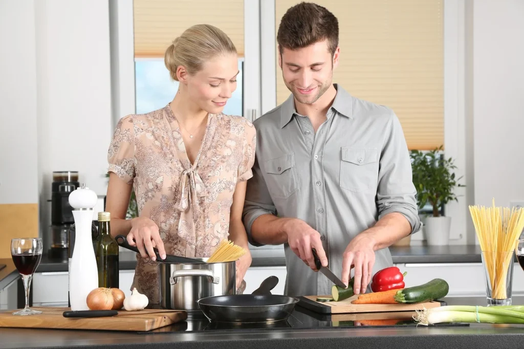 Couple talking together at a kitchen table while planning for a family